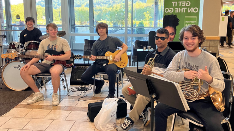 a group of male students playing instruments 